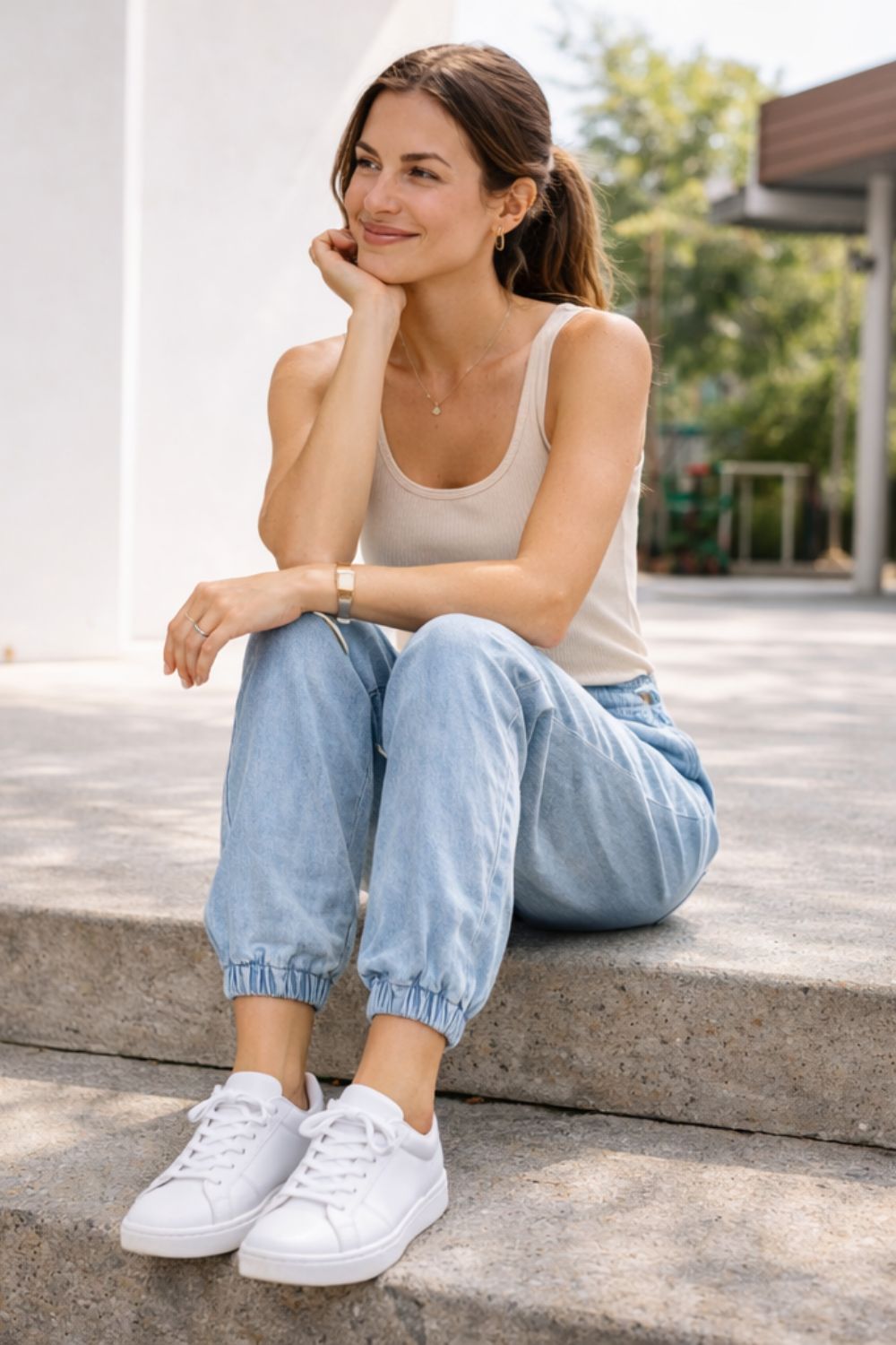 Summer athleisure outfit featuring classic white sneakers with joggers and tank top for women